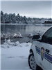 Sheriff Cruiser Car Parked Next to Snowy Lake