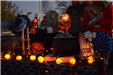 Woman in Costume Standing Next to Halloween-Decorated Table