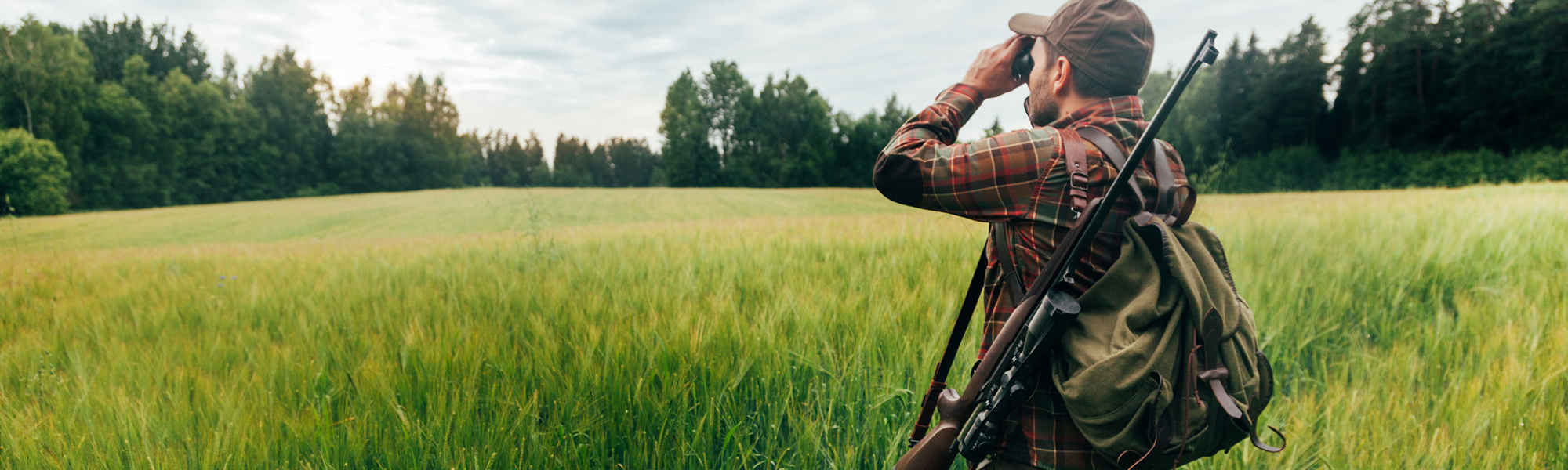 Hunting Looking Through Binoculars Across a Field