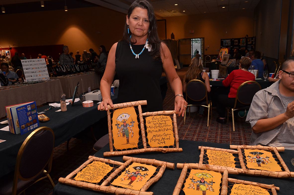 Woman Displaying Handmade Goods at a Table