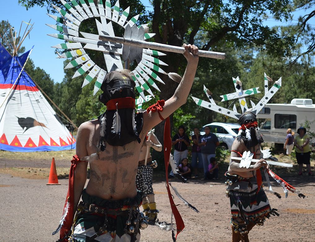 People in Traditional Native American Attire Dancing
