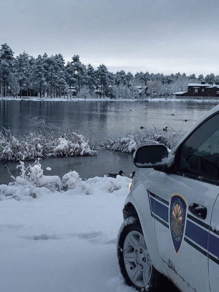 Sheriff Cruiser Car Parked Next to Snowy Lake