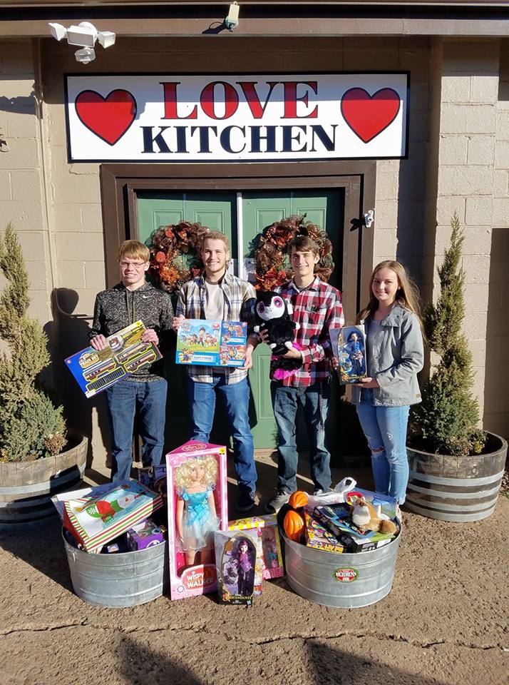 Four Teens Holding Toys